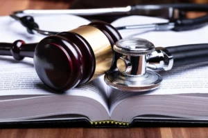 A gavel, legal book, and stethoscope lie together, symbolizing the legal grounds for filing an Ozempic lawsuit.